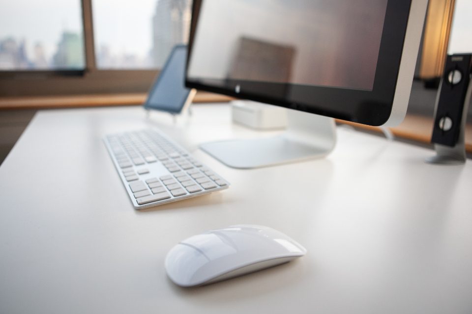 Modern desktop computer monitor with a wireless keyboard and mouse