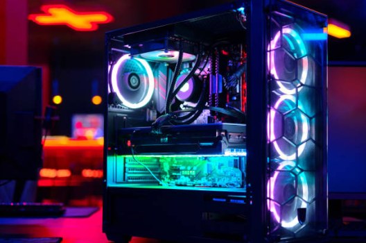 Custom-built gaming desktop PC tower with a tempered-glass side panel and colorful RGB lighting