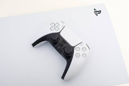 PlayStation 5 console with its white DualSense wireless controller