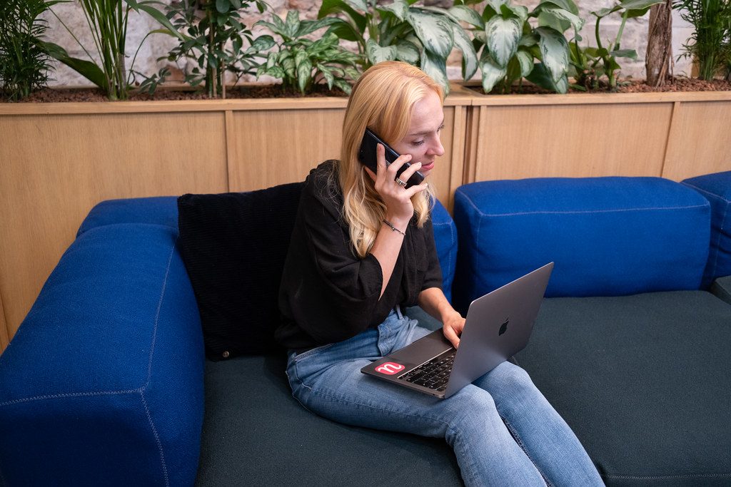 Customer getting remote technical support by phone while using a laptop